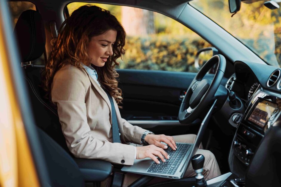 auto car insurance, woman on laptop in car